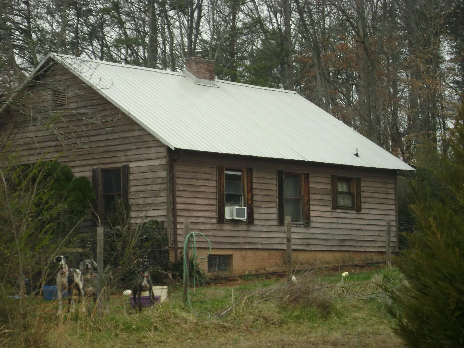 White metal roof on an old wood sided farmhouse, from a Metal Roof Installation job in North Chatham